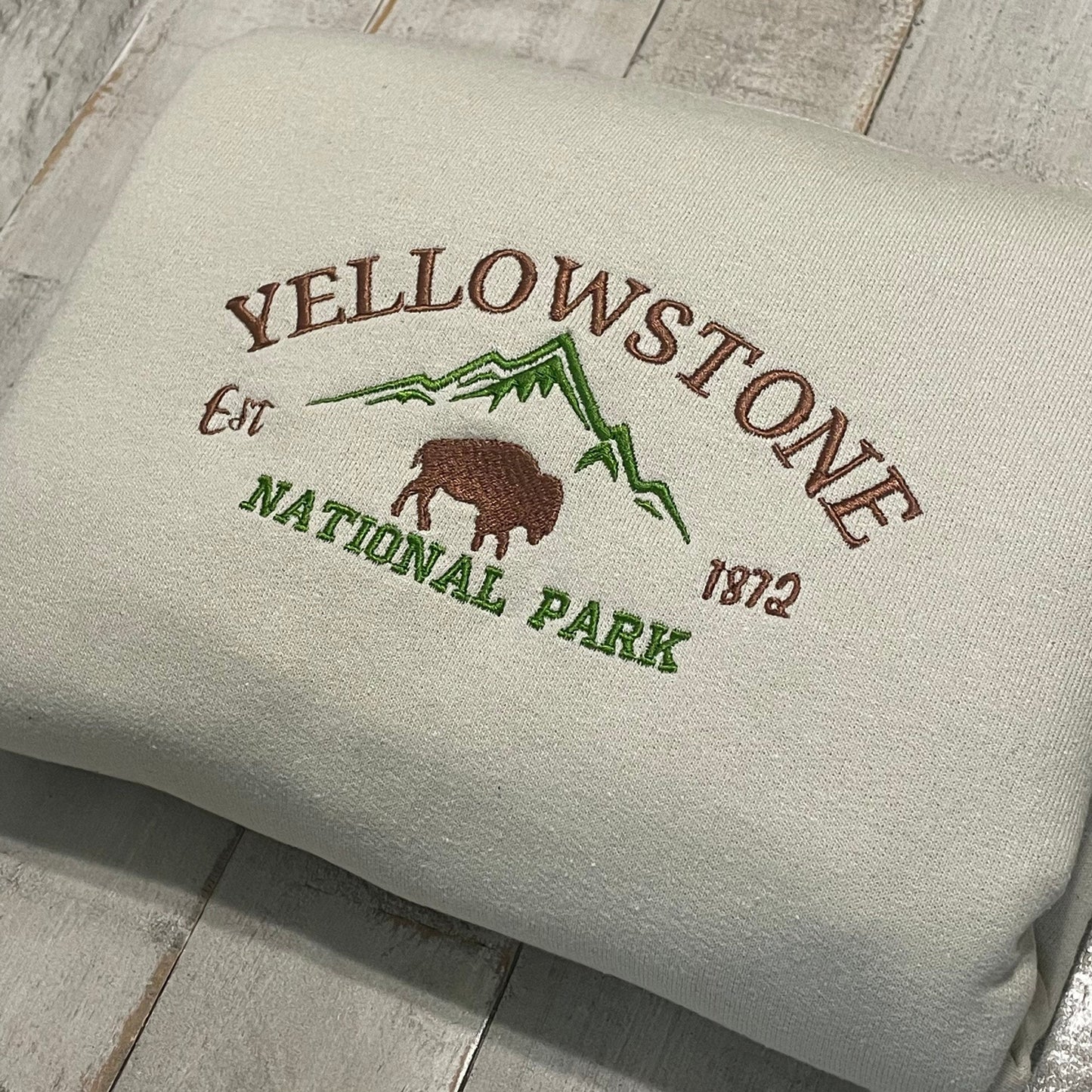 Yellowstone Embroidered Sweatshirt featuring a buffalo and mountain design.