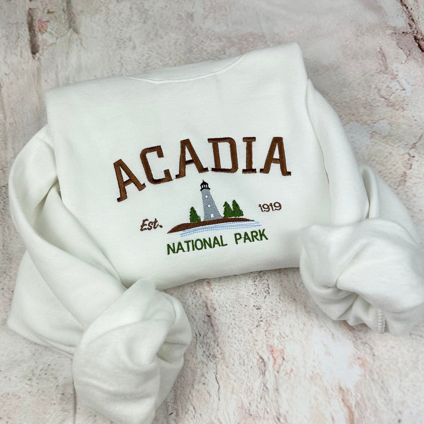 Acadia National Park embroidered crewneck sweatshirt with lighthouse design.