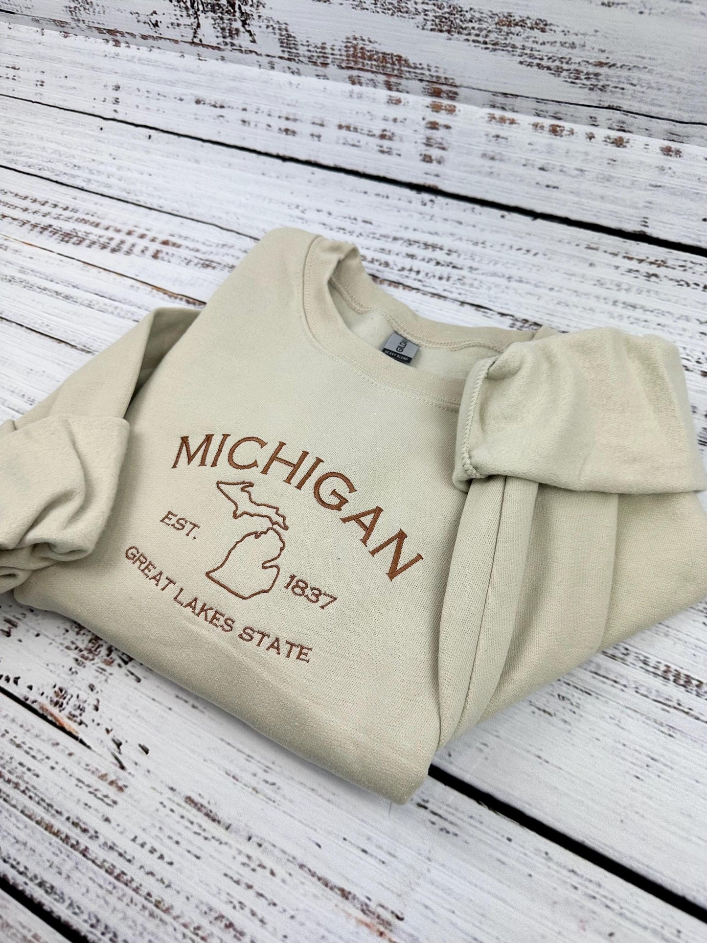 Michigan embroidered sweatshirt with Great Lakes design on cream crewneck.