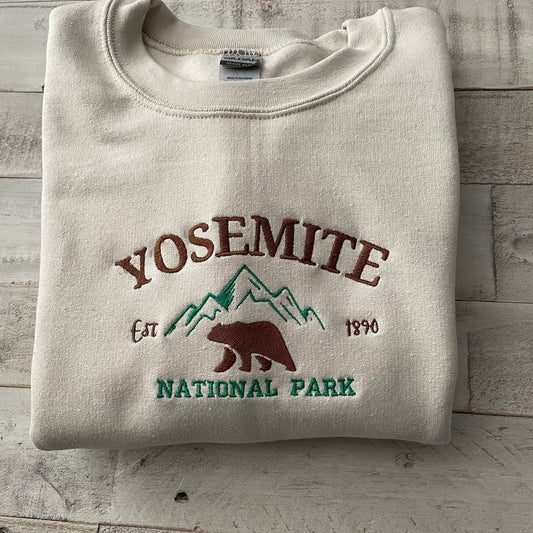 Yosemite National Park embroidered crewneck sweatshirt with mountain and bear design.