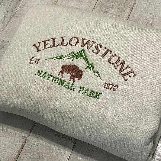 Yellowstone Embroidered Sweatshirt featuring a buffalo and mountain design.