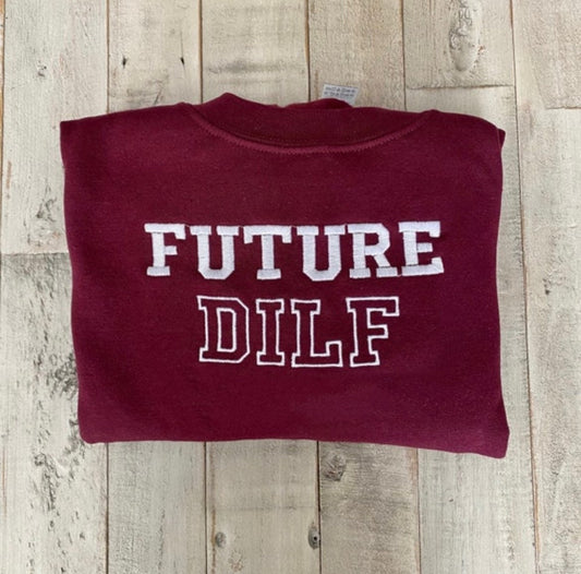 Trendy maroon crewneck sweatshirt with "Future Dilf" embroidery.