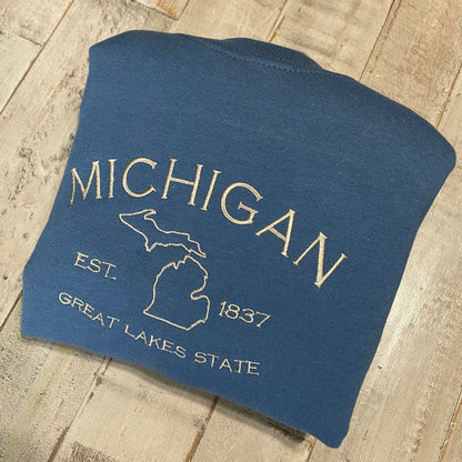 Michigan embroidered sweatshirt with Great Lakes design on blue crewneck.