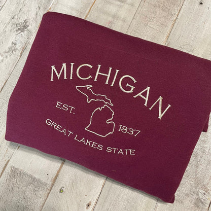 Michigan Embroidered Sweatshirt featuring Great Lakes design on a folded crewneck.