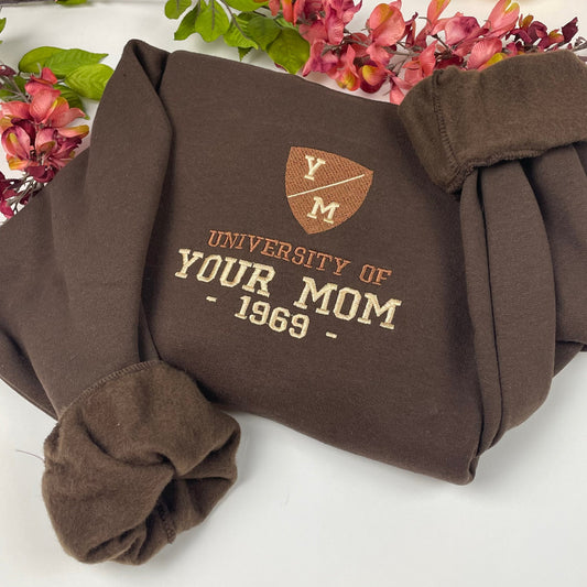 Unisex sweatshirt with "University of Your Mom 1969" embroidered design.