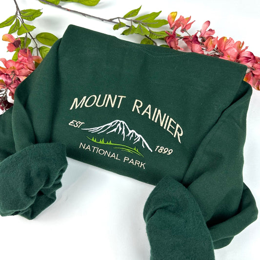 Mount Rainier National Park embroidered crewneck sweatshirt, green, surrounded by pink and green flowers.