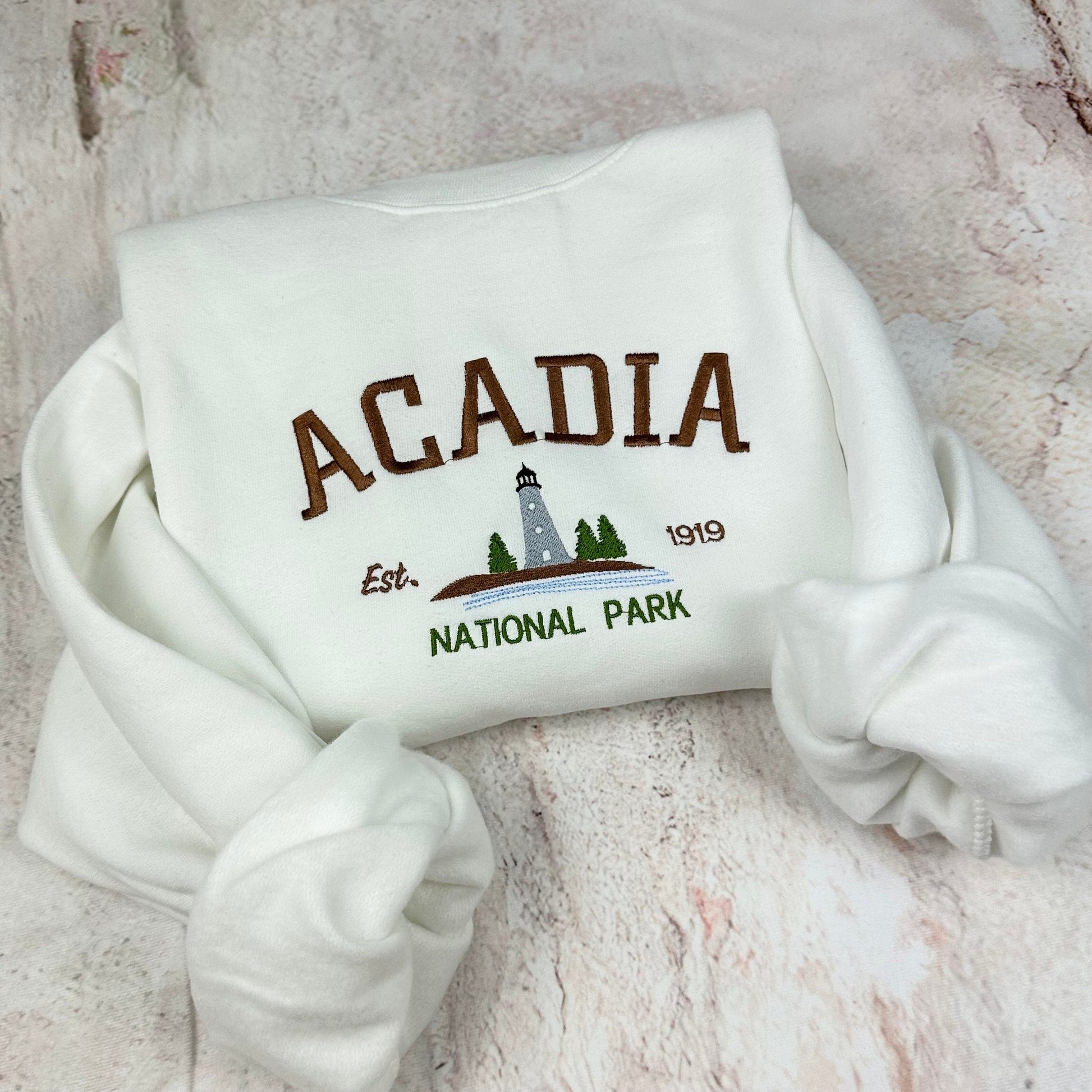 Acadia National Park embroidered crewneck sweatshirt with lighthouse design.