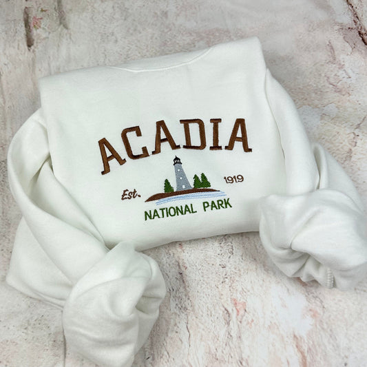 Acadia National Park embroidered crewneck sweatshirt with lighthouse design.