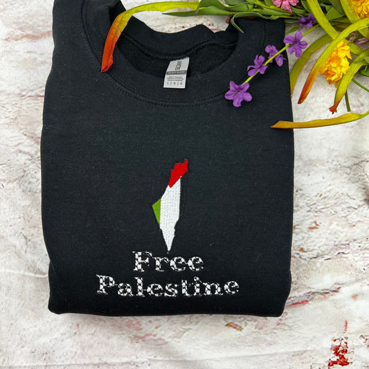 Embroidered Free Palestine crewneck sweatshirt on display with floral accents.