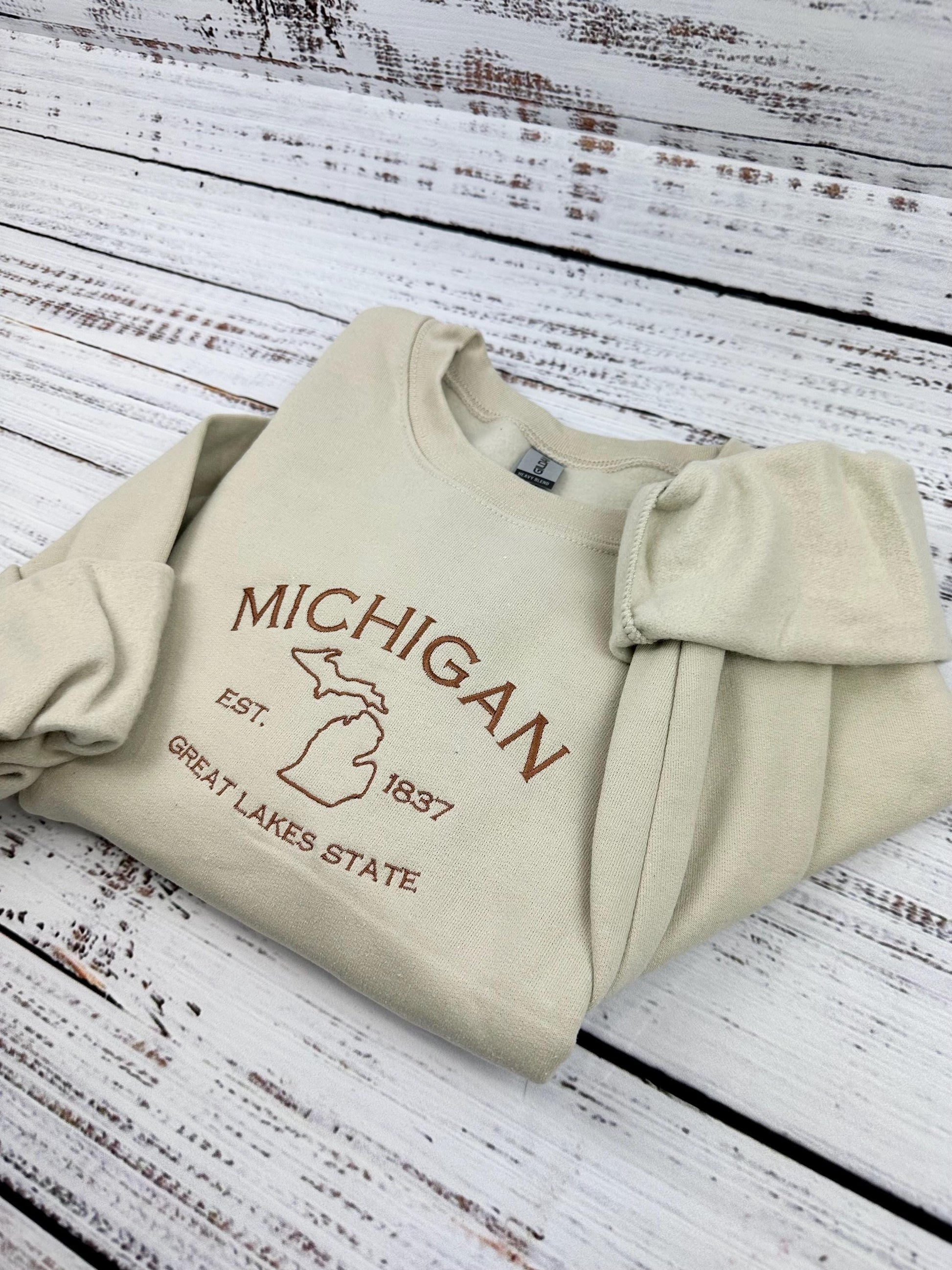 Michigan embroidered sweatshirt with Great Lakes design on cream crewneck.