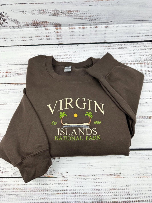 Virgin Islands National Park Hoodie with St. John design, brown color, folded on wood background.