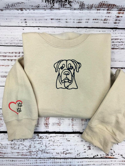 Custom dog embroidered hoodie with outlined dog design and heart paw sleeve decoration.