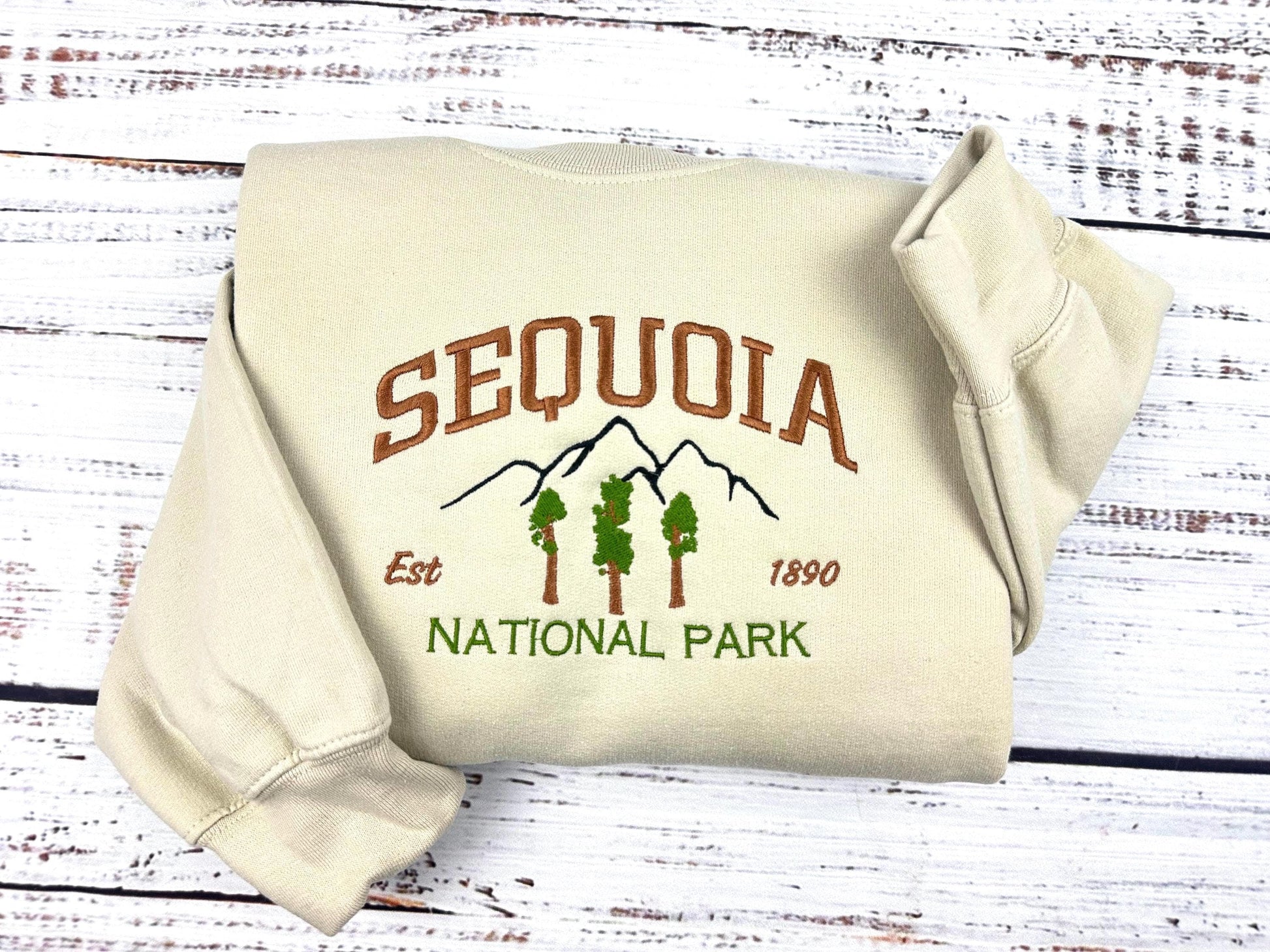Sequoia National Park embroidered crewneck sweatshirt, unisex, folded with tree and mountain design.