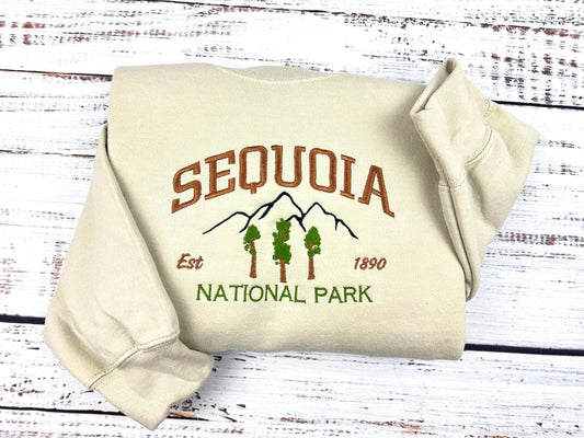 Sequoia National Park embroidered crewneck sweatshirt, unisex, folded with tree and mountain design.